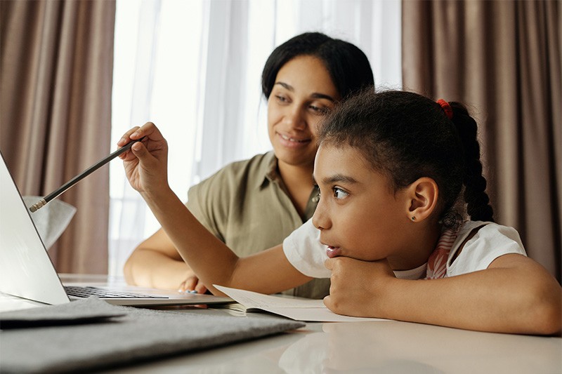 Student and parent looking at a laptop together